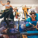 Two One Piece anime character figurines are displayed in a shop, each with a yen price tag on their heads—a common sight in Akihabara Hobby Stores, where shelves are filled with more anime figures and merchandise.